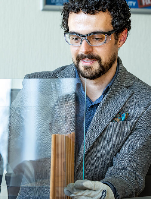 Man inspecting a piece of glass